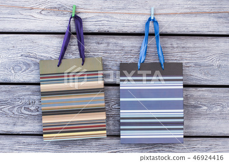 Two gift bags hanging on rope. Two gift bags hanging on rope. 46924416