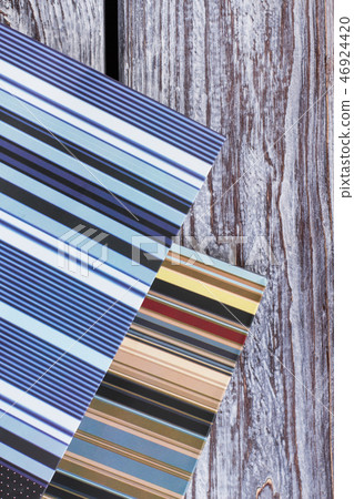 Striped gift bags on wooden background. Striped gift bags on wooden background. 46924420