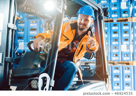 Worker showing thumbs up in logistics delivery center 46924535