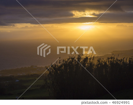 Aerial view of Vila Franca do Campo town volcanic islet during orange sunset with clouds, contre Aerial view of Vila Franca do Campo town volcanic islet during orange sunset with clouds, contre 46924991