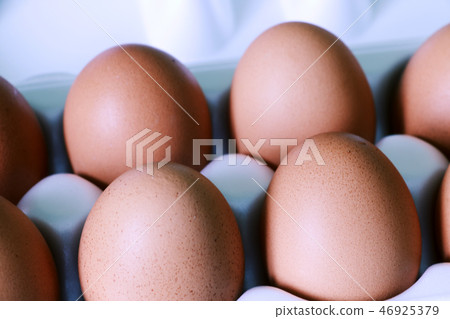 Yellow chicken eggs in a carton with empty space, background. Yellow chicken eggs in a carton with empty space, background. 46925379
