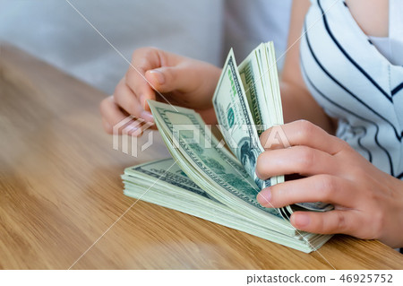Selective focus female hand counting banknote Selective focus female hand counting banknote 46925752