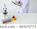 Lab staff write the test results of research 46929773