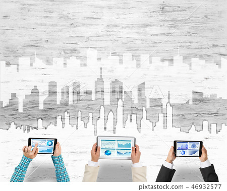 Top view of businesspeople sitting at table and using gadgets 46932577