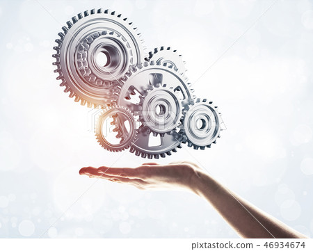 Concept of teamwork and cooperation presented with working gear Concept of teamwork and cooperation presented with working gear 46934674