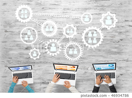 Top view of businesspeople sitting at table and using gadgets Top view of businesspeople sitting at table and using gadgets 46934786