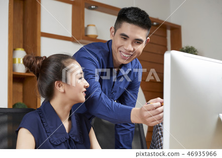 Businessman showing work to colleague 46935966