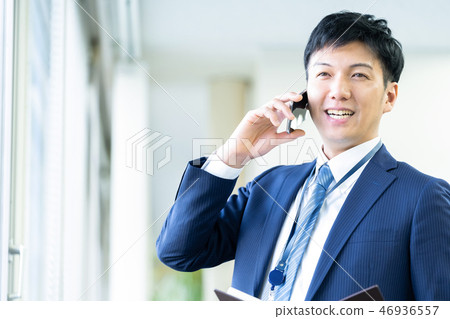 Male employee who calls a young businessman Male employee who calls a young businessman 46936557