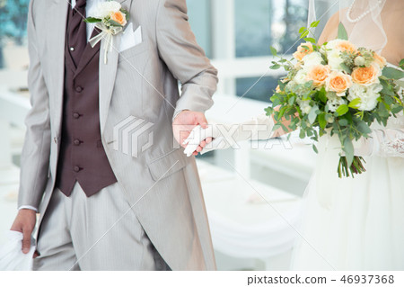 A groom that escorts a bride 46937368