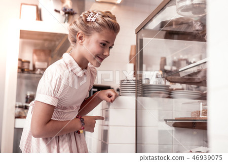 Happy delighted girl looking at the display Happy delighted girl looking at the display 46939075