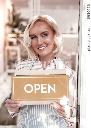 Delighted attractive blonde woman smiling to you Delighted attractive blonde woman smiling to you 46939616