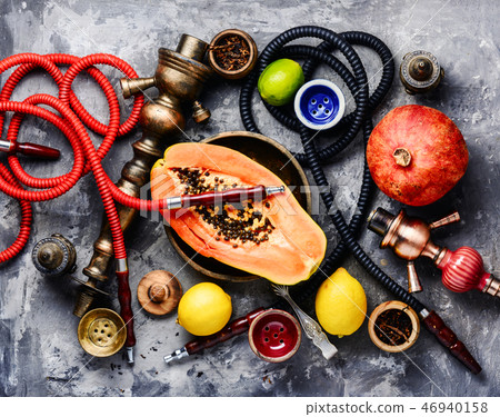 Smoking hookah with tobacco papaya Smoking hookah with tobacco papaya 46940158