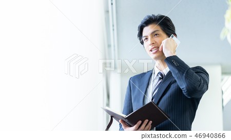 Male employee who calls a young businessman Male employee who calls a young businessman 46940866