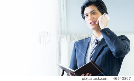 Male employee who calls a young businessman Male employee who calls a young businessman 46940867