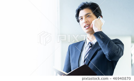 Male employee who calls a young businessman Male employee who calls a young businessman 46940870