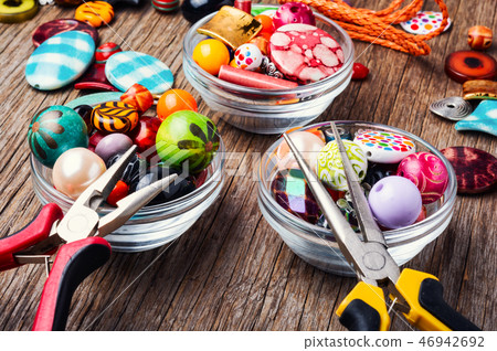 Colorful beads on a wooden surface 46942692