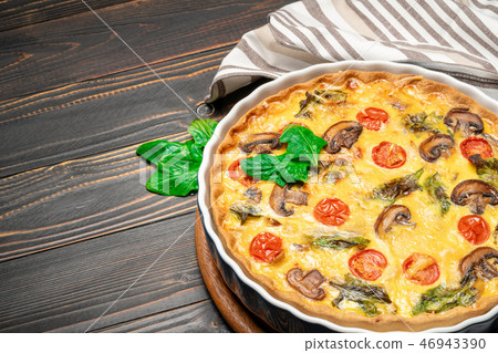 Baked homemade quiche pie in ceramic baking form Baked homemade quiche pie in ceramic baking form 46943390