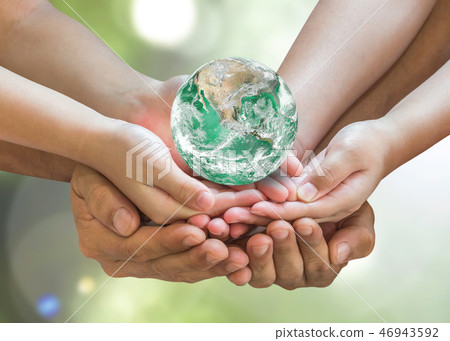 Green globe in family volunteer hands earth day Green globe in family volunteer hands earth day 46943592