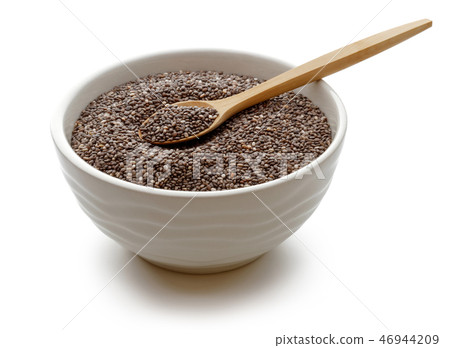 Chia seeds in white bowl and wooden spoon 46944209