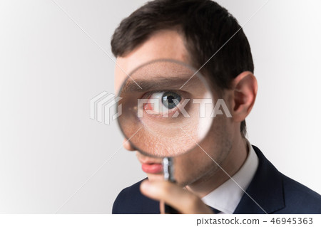 A man watching with a magnifying glass 46945363