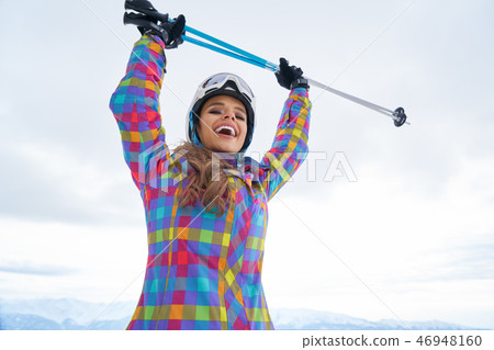 Woman Skier Standing at Snow Looking at Camera. Winter Montain Woman Skier Standing at Snow Looking at Camera. Winter Montain 46948160