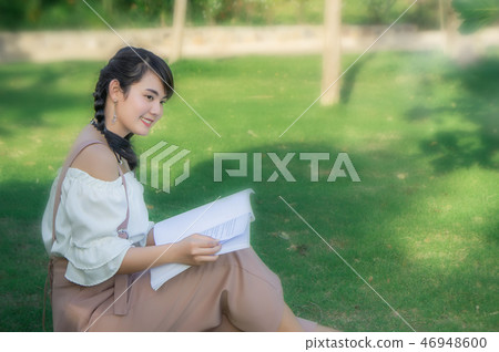 the asian girl's sitting in the park and reading  46948600