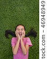 kid asian girl's lie leisurely on the Lawn floor 46948949