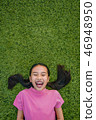 kid asian girl's lie leisurely on the Lawn floor 46948950