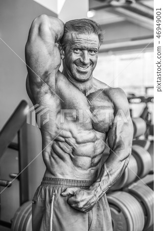 Brutal aged strong bodybuilder athletic men pumping up muscles w Brutal aged strong bodybuilder athletic men pumping up muscles w 46949001
