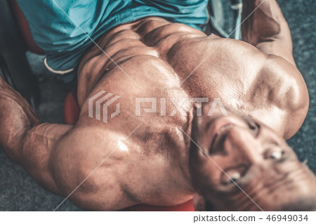 Brutal aged strong bodybuilder athletic men pumping up muscles w 46949034