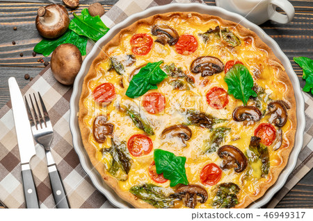 Baked homemade quiche pie in ceramic baking form Baked homemade quiche pie in ceramic baking form 46949317