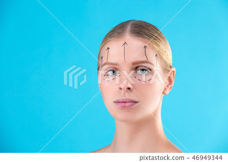 Beautiful Woman Face. Beauty Portrait of young woman blond, painted lines on the face for cosmetic 46949344