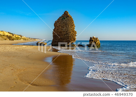 Old ruined defense tower near ocean in the beach Old ruined defense tower near ocean in the beach 46949370