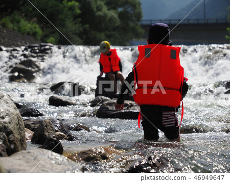 Children play river in a mountain stream 46949647