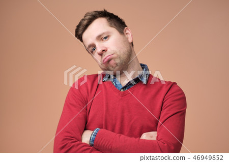 Sad young man in red sweater is exhausted  46949852