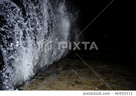 Splashing wave on the Black sea in the night. Splashing wave on the Black sea in the night. 46950311