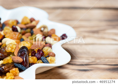 Mix of nuts and berries. Dried fruits in plate 46951274