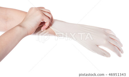 above view of hand pulls latex glove on hand above view of hand pulls latex glove on hand 46951343