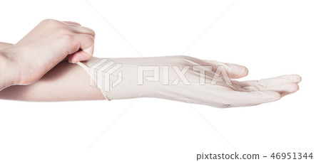 profile view of hand pulls latex glove on hand profile view of hand pulls latex glove on hand 46951344