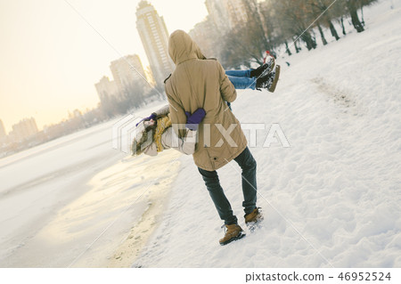 Theme outdoor activities in winter. Loving couple man and woman Caucasian joy happiness happiness Theme outdoor activities in winter. Loving couple man and woman Caucasian joy happiness happiness 46952524