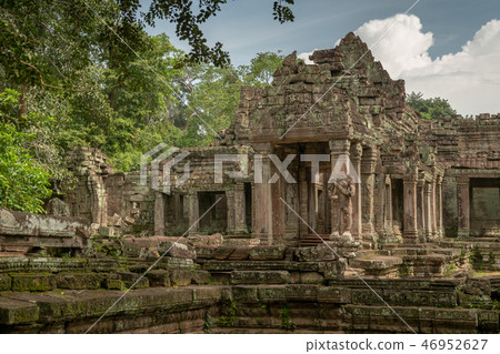 Facade of ruined stone temple in trees Facade of ruined stone temple in trees 46952627