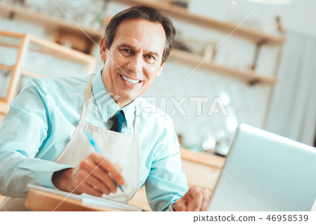 Handsome man watching on a laptop Handsome man watching on a laptop 46958539