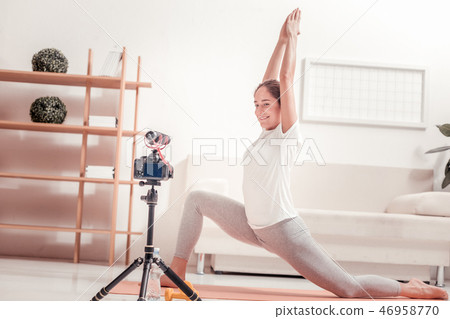 Young trainer showing an exercise 46958770