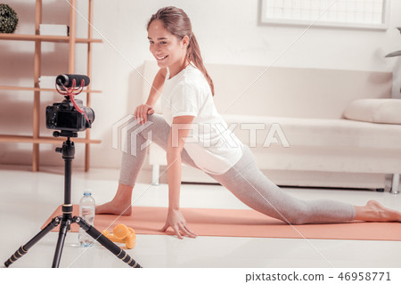 Joyful woman recording a video of a training Joyful woman recording a video of a training 46958771