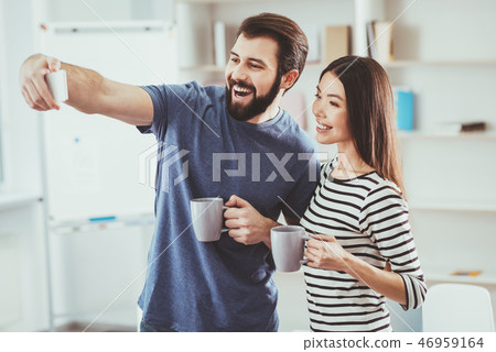 Joyful bearded man taking a selfie 46959164
