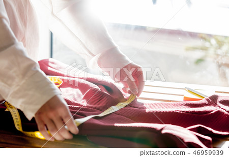 fashion designer hands with dress and measure tape fashion designer hands with dress and measure tape 46959939