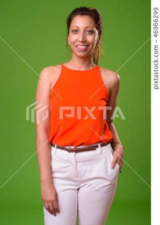 Beautiful businesswoman against green background 46966299