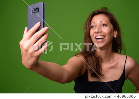 Beautiful woman against green background 46966300