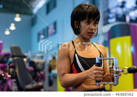 Young woman working back with seated cable row Young woman working back with seated cable row 46966562