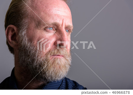 Close up portrait of mature bearded man thinking Close up portrait of mature bearded man thinking 46966878